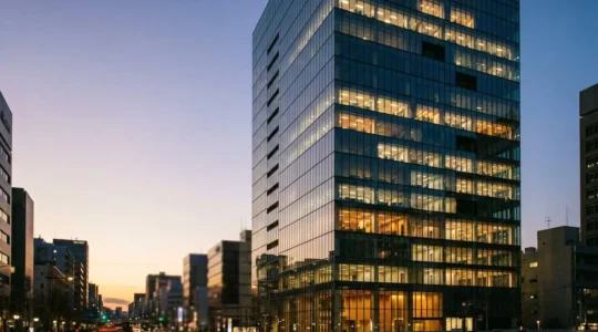 Contemporary glass office building with empty and occupied floors showing hybrid work reality