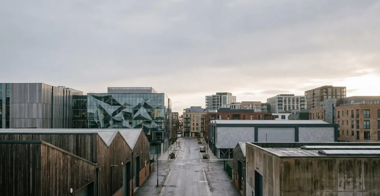 Modern UK commercial property skyline showcasing diverse sector buildings including logistics warehouses and office towers under natural light