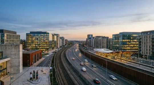 Wide-angle view of modern UK urban development corridor with transport infrastructure and commercial buildings